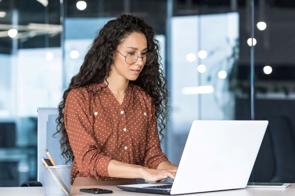 Higher ed job seeker conducting salary research on laptop