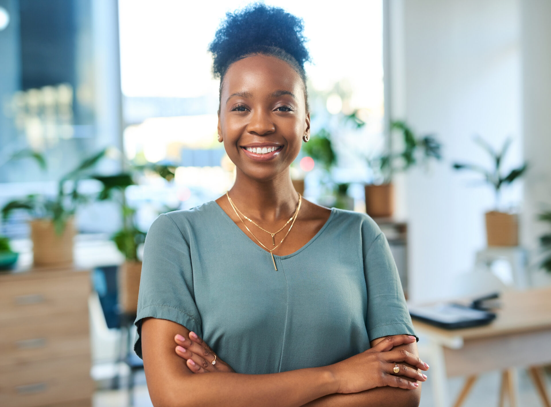 Professional woman smiling with arms crossed