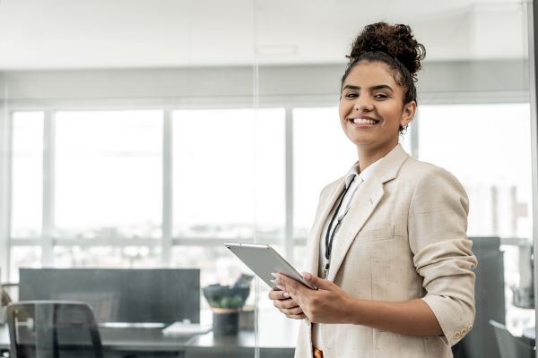 Latino professional holding tablet in the office