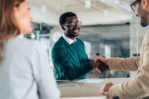 Tips for Navigating Panel Interviews: Candidate shaking hands with a panelist